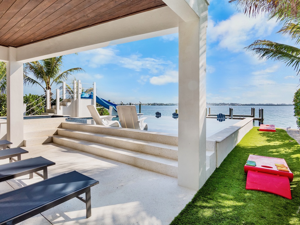 Sun Loungers with Pool Views and Cornhole