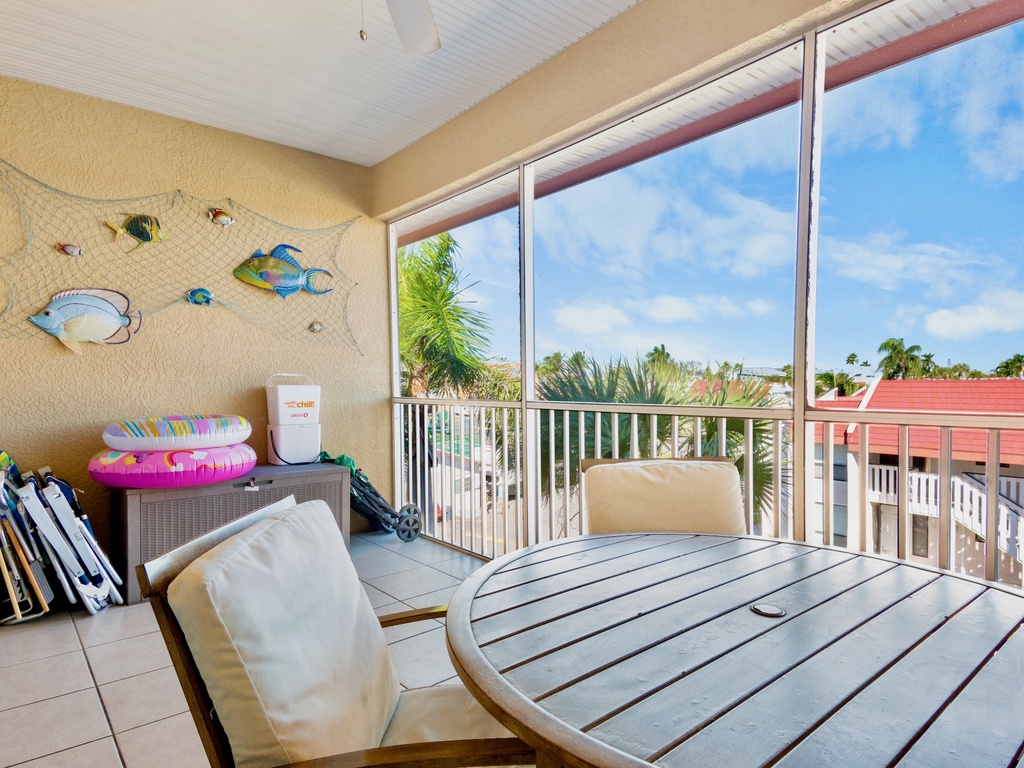 Screened-in balcony with dining table