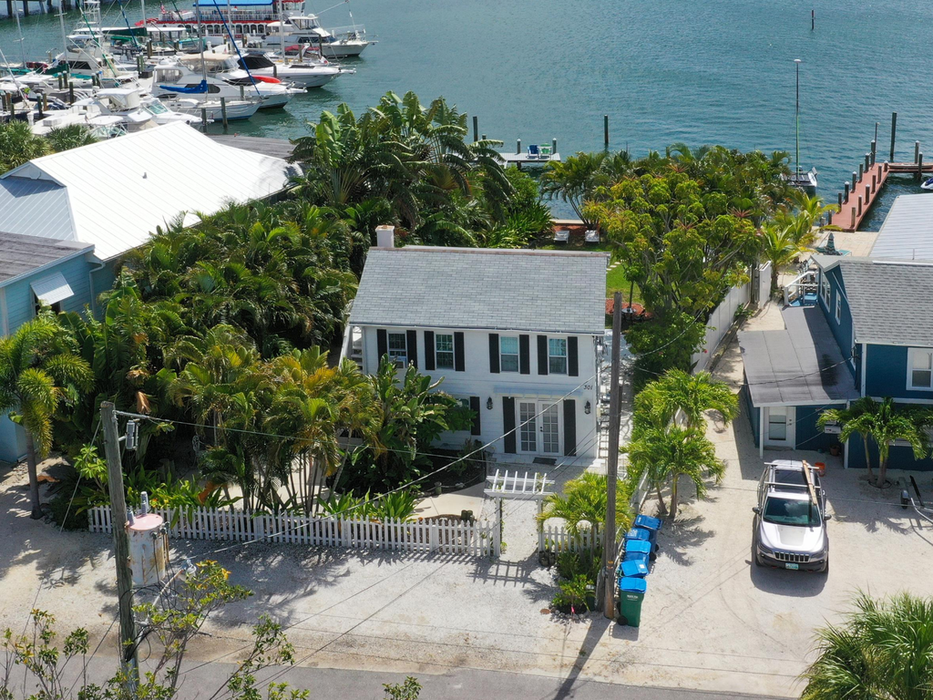 Charming waterfront property with private marina access and tropical landscaping in peaceful coastal neighborhood.