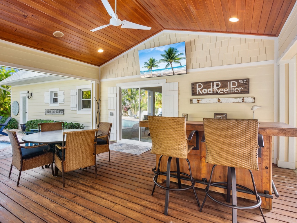 Bar with seating and a large TV