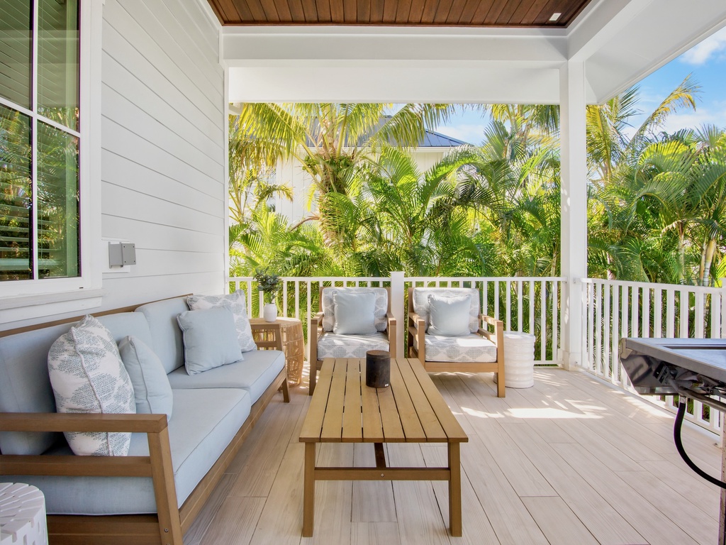 Private covered terrace with comfortable seating and a BBQ grill