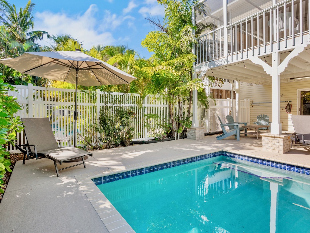 Private pool oasis surrounded by lush tropical palms