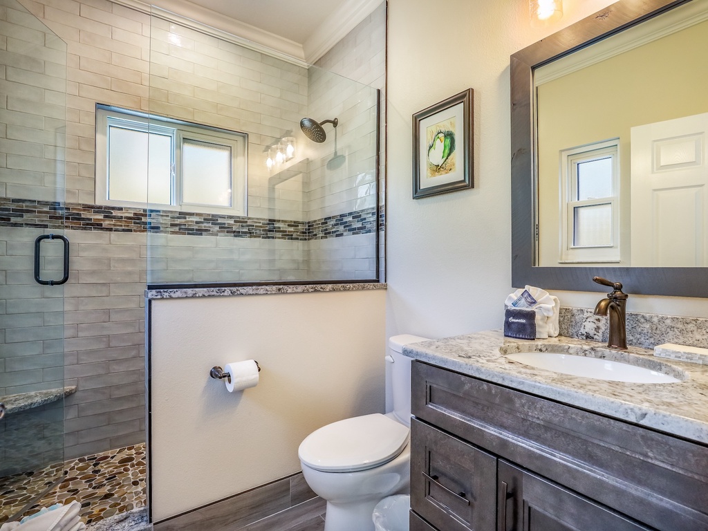Your elegant bathroom features granite counters, subway tile shower, and thoughtful amenities for a refreshing start to each day.