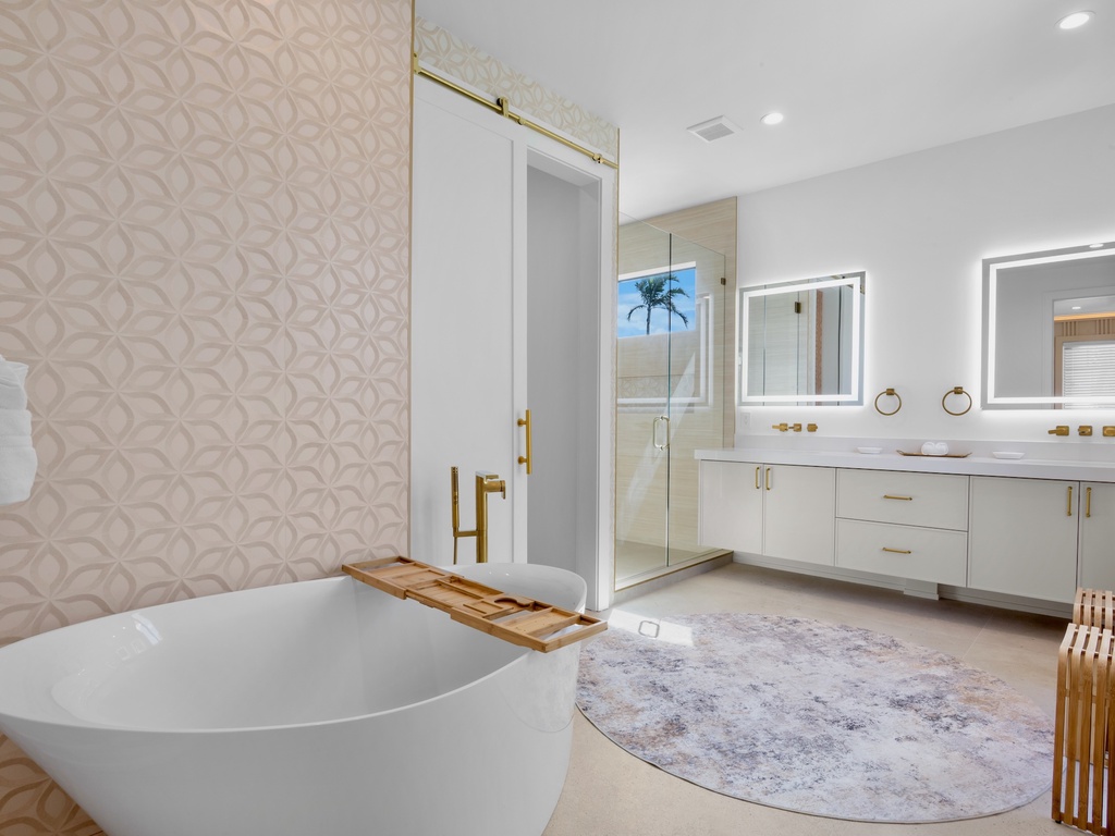 Primary bathroom with walk-in shower and standalone soaking tub