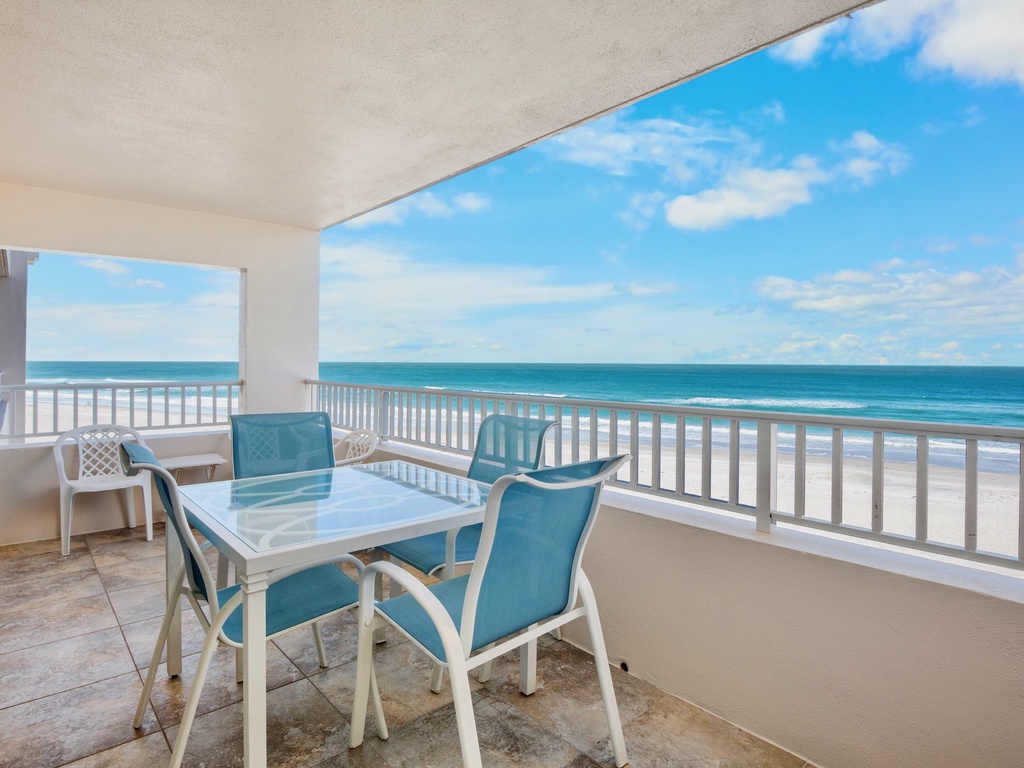Private oceanfront balcony with dining