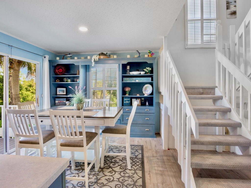 Dining space opens to tropical views, with built-in storage