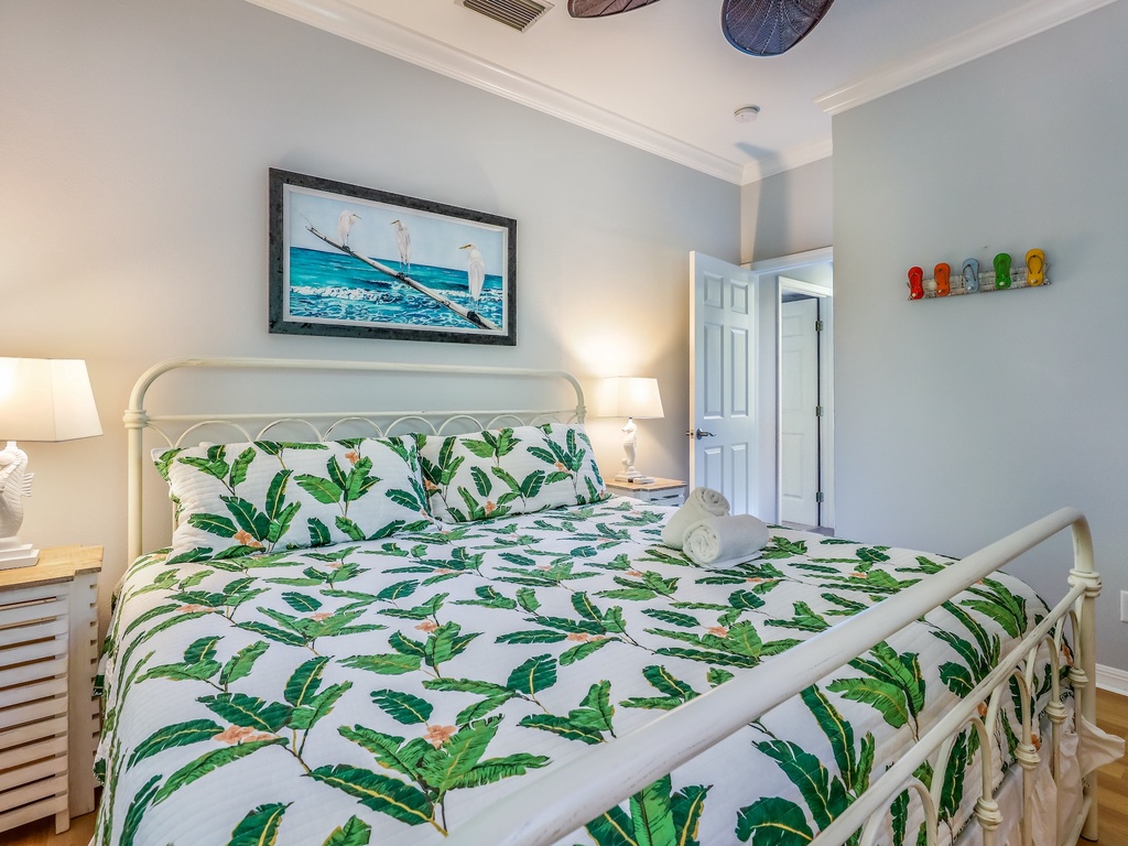 Drift off in your coastal-themed bedroom featuring tropical palm leaf linens and charming nautical touches that create a serene island escape.