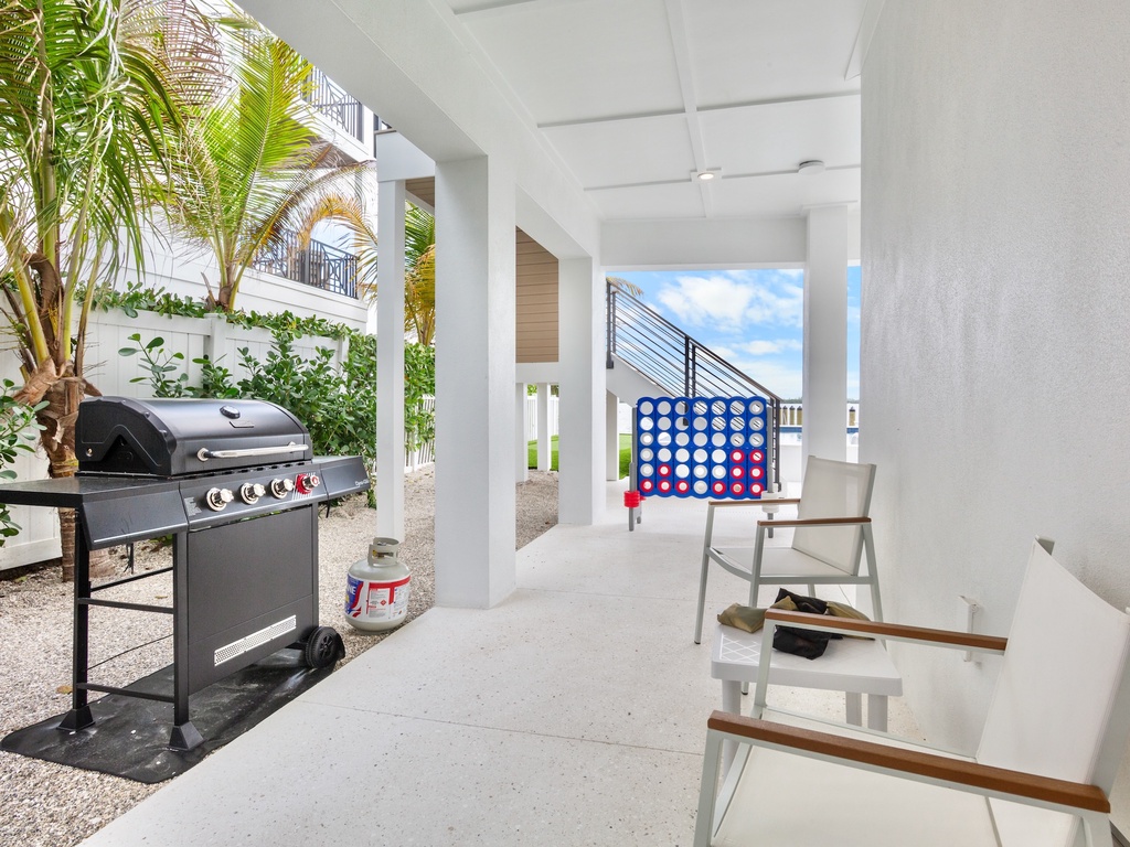 Covered outdoor space with games and BBQ grill