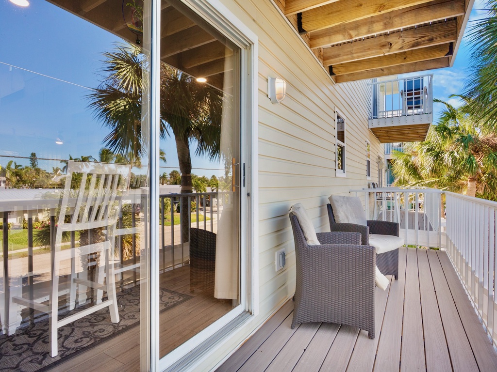 Step onto your private balcony with wicker seating where tropical breezes and swaying palms create the perfect spot for morning coffee or sunset relaxation.