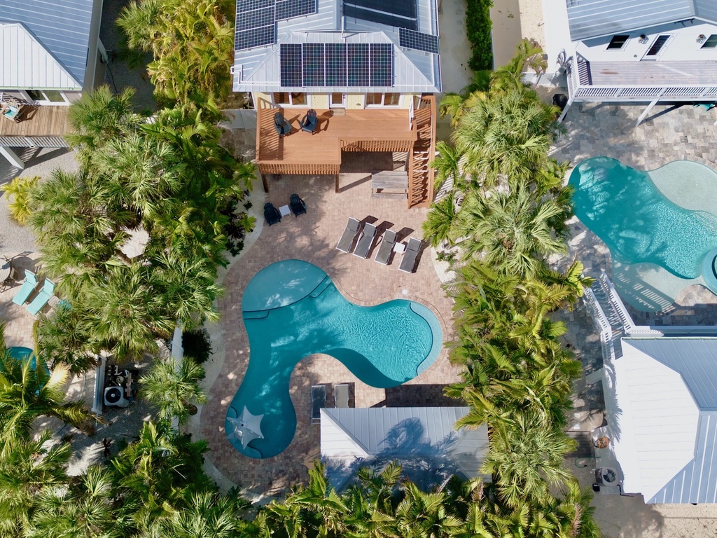 Tropical home featuring a private pool