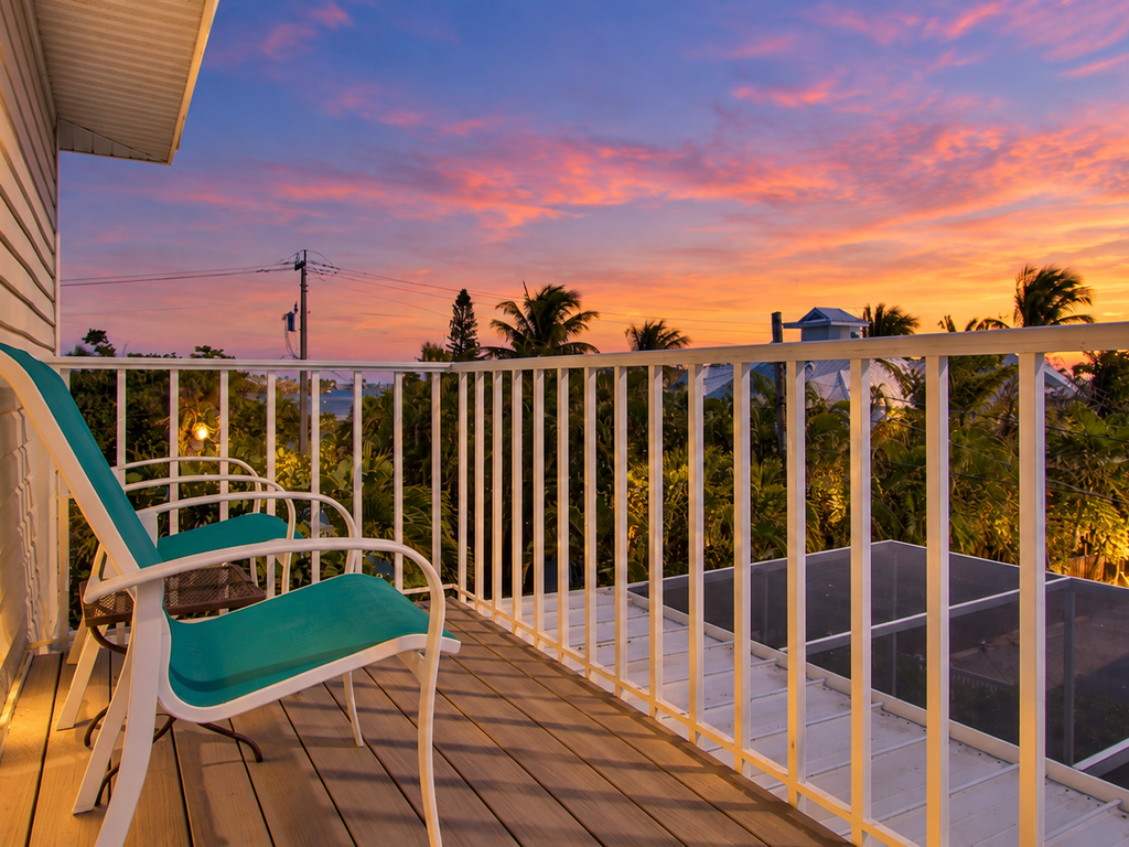 Private balcony with chairs at sunset