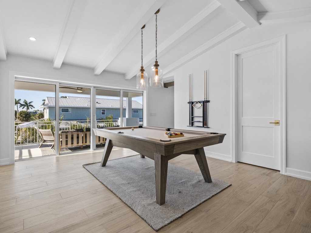 Indoor game room with pool table with tropical views