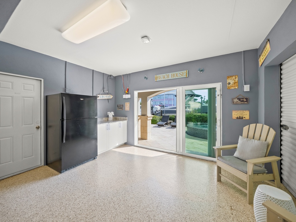 Private garage features kitchenette, seating area, and direct pool access