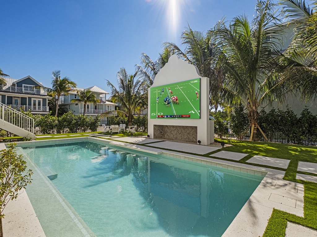 Private pool featuring an outdoor entertainment wall
