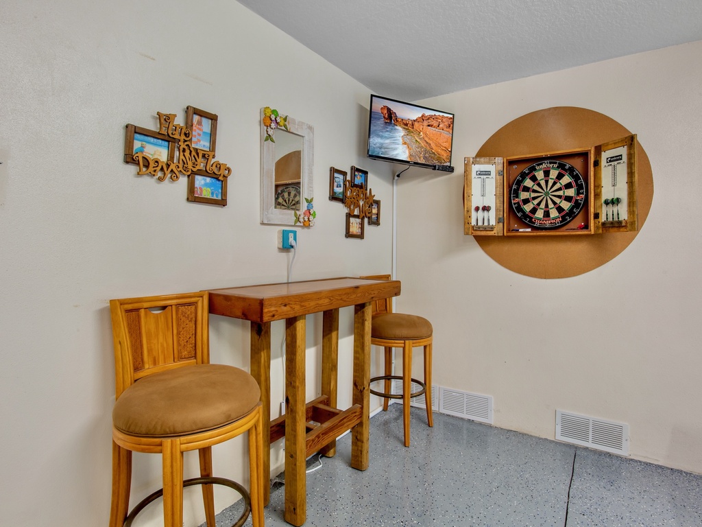 Game room with a dartboard and high-top seating