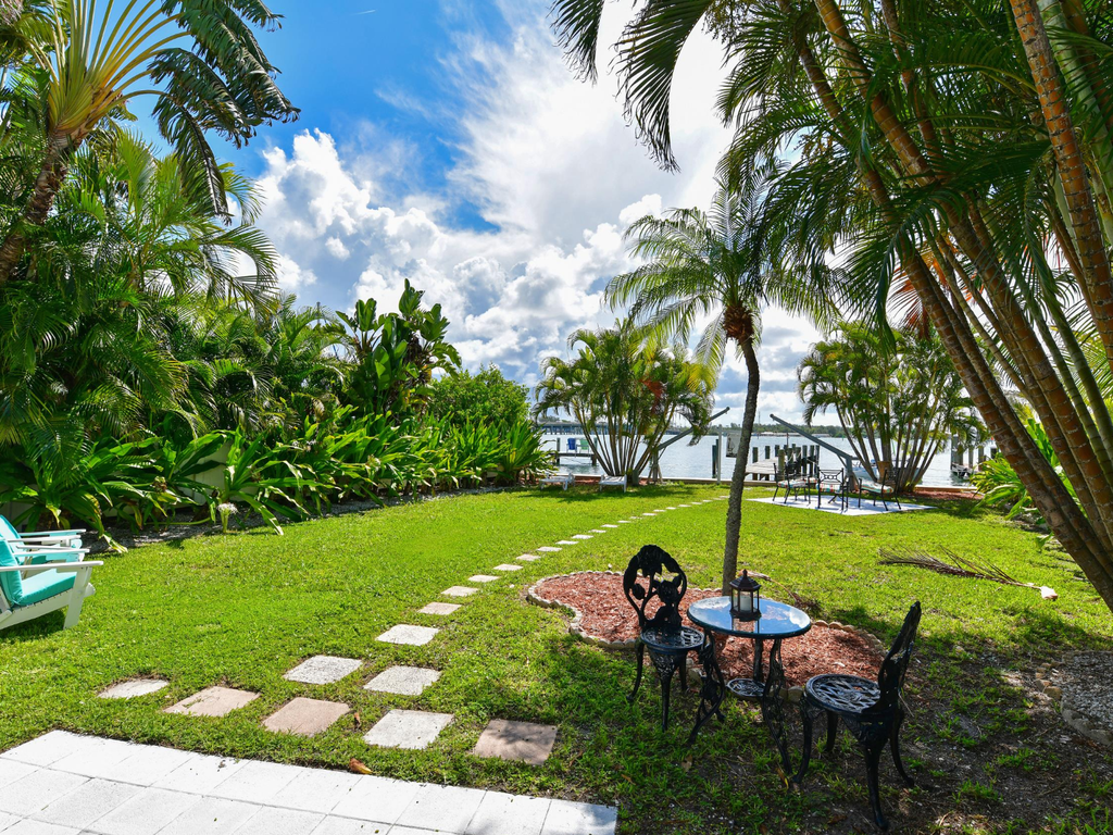 Your private tropical oasis awaits with lush gardens, waterfront dining, and swaying palms creating the perfect island escape.