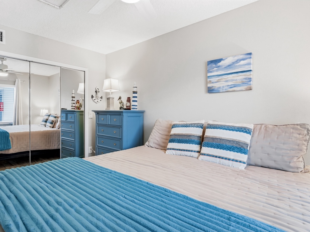 Relax in your coastal-themed bedroom featuring ocean-blue accents and plush bedding that invites peaceful sleep.