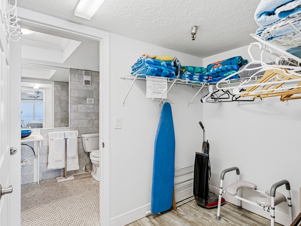 Your walk-in closet offers convenient storage with hangers and shelving, plus easy access to your private bathroom.
