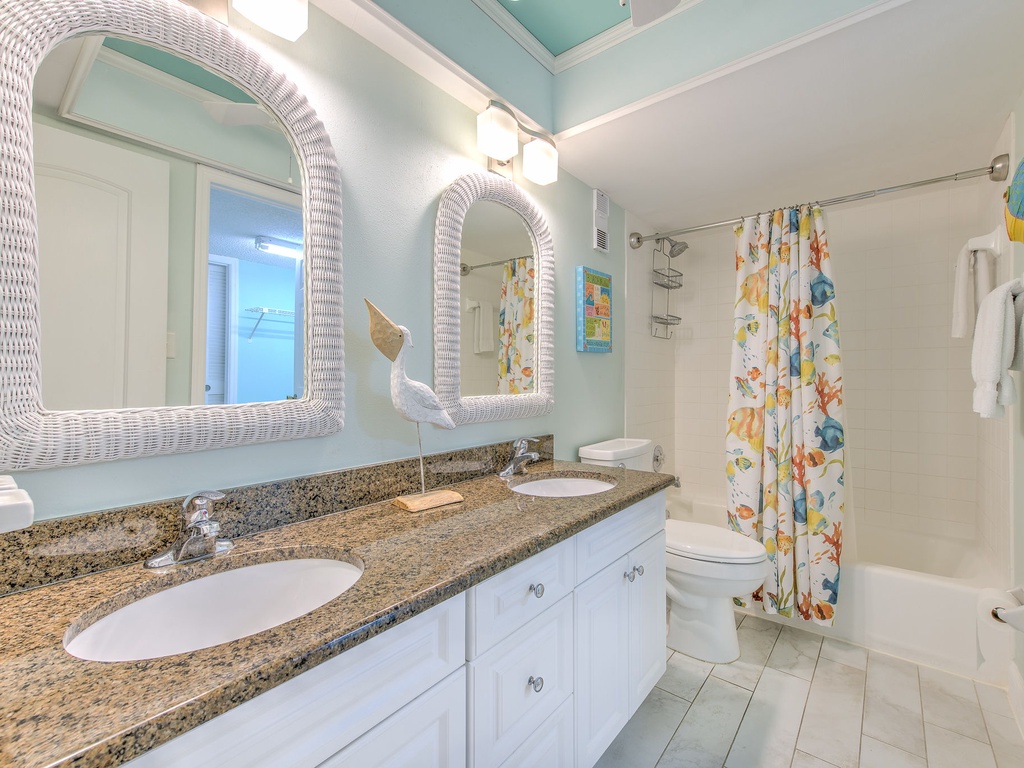 Refresh in your coastal-inspired bathroom with dual sinks, granite counters, and cheerful sea-themed touches that make morning routines feel like vacation.