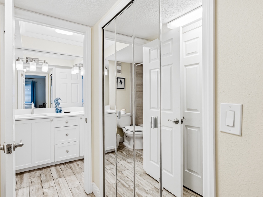 Step into your bright ensuite with mirrored closets and modern vanity - perfect for getting ready in your spacious retreat.