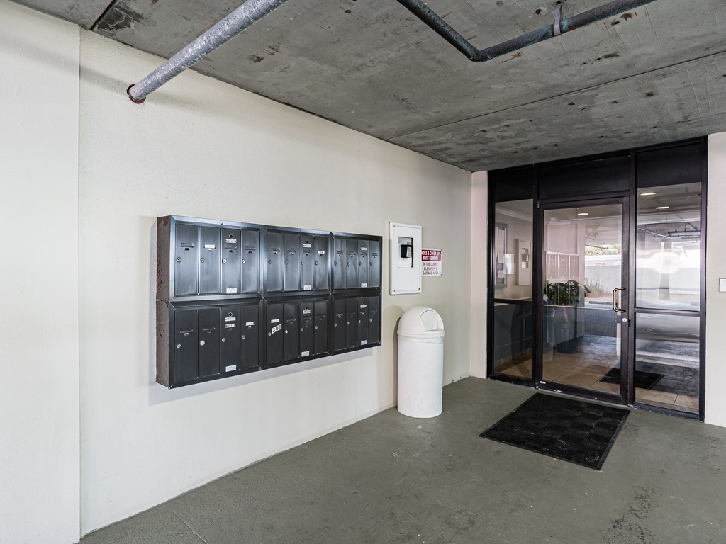 Modern building entrance with mailboxes and glass doors for easy access.