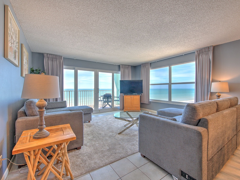 Wake up to endless ocean views from your comfortable living room, where plush seating and a private balcony create the perfect coastal retreat.