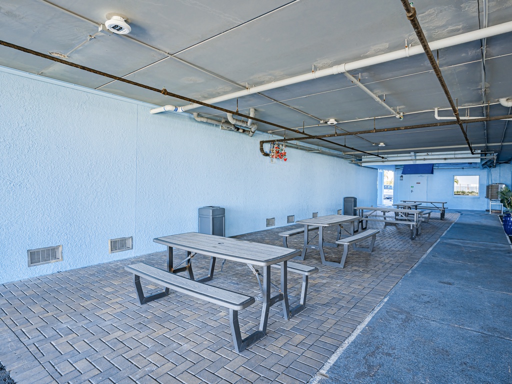 Spacious covered terrace with picnic tables where you can gather for meals and relaxation in any weather.