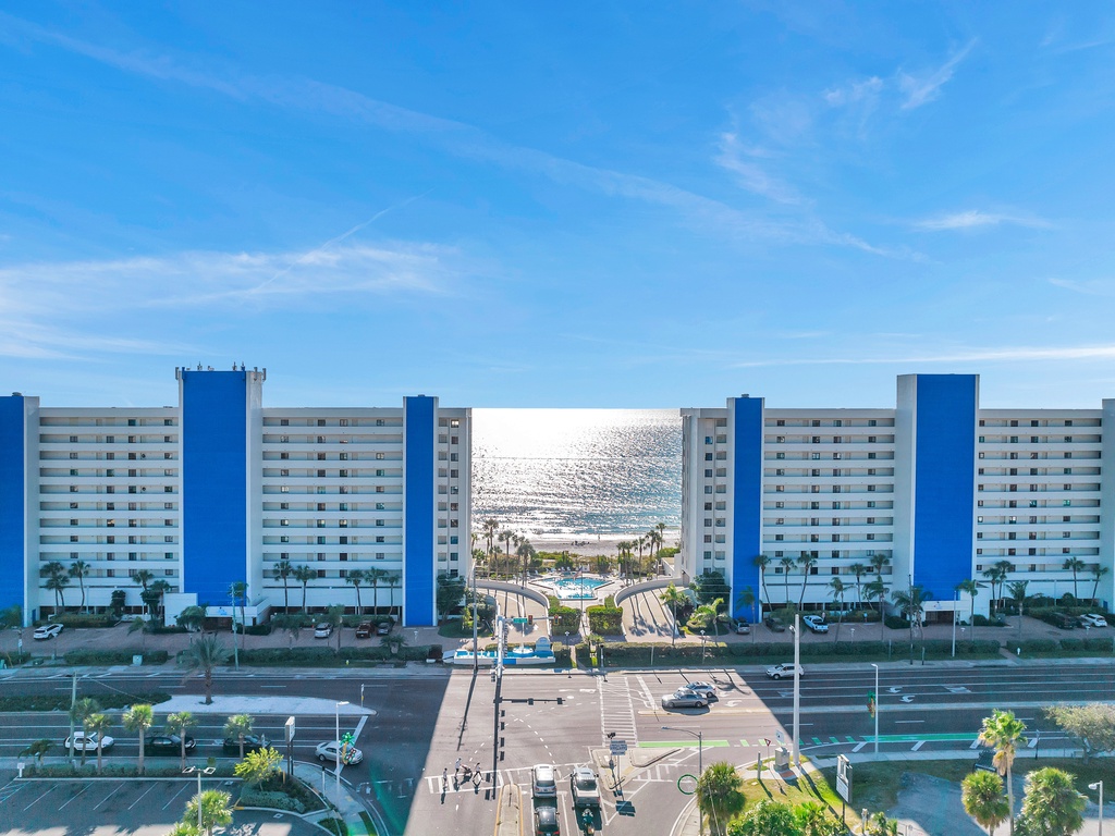 Beachfront hotel complex with twin blue and white towers offering direct ocean access and stunning coastal views.