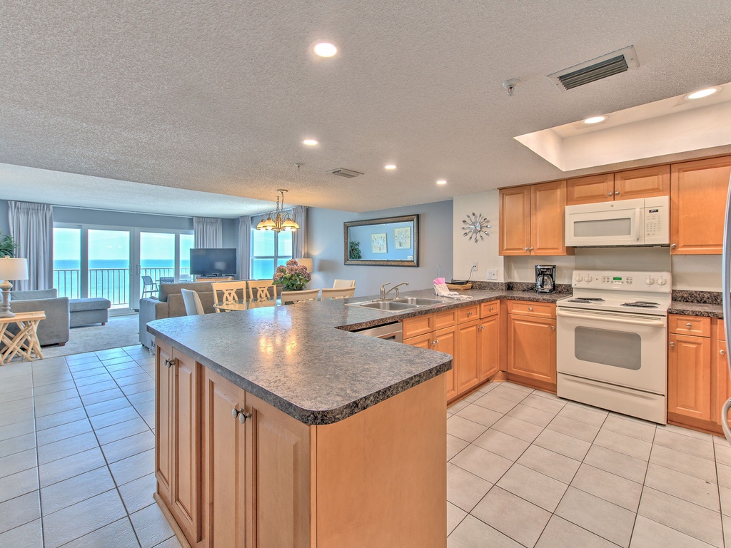 Your spacious kitchen features granite counters and modern appliances, opening to a bright living area with stunning ocean views.