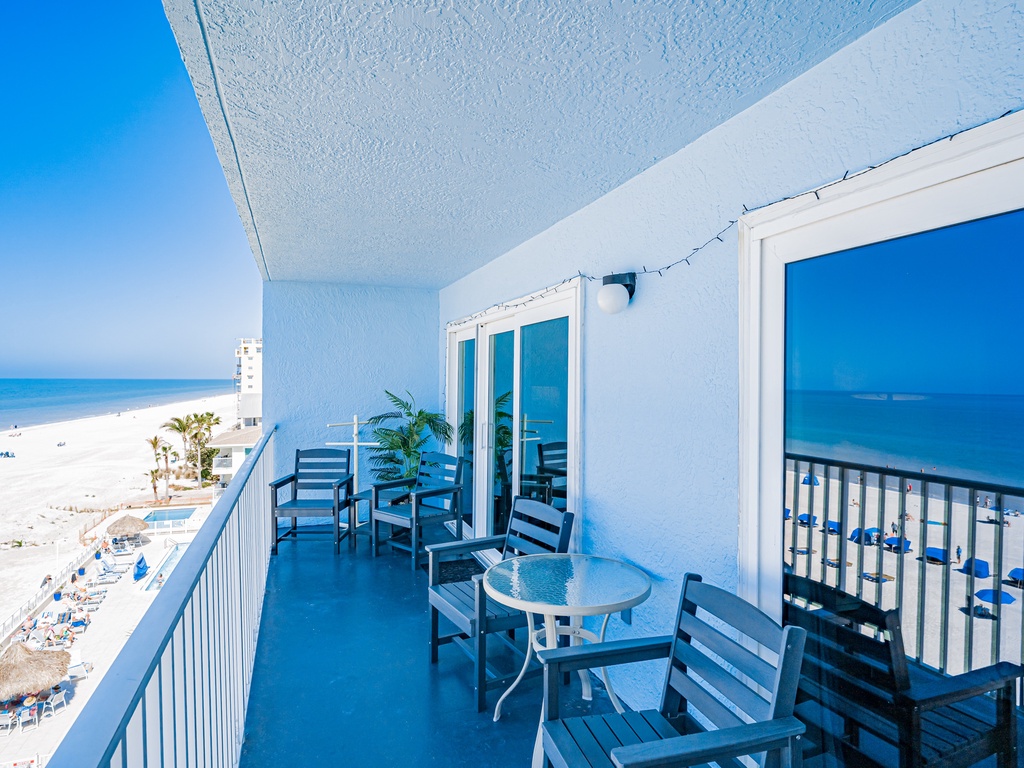 Your private beachfront balcony offers stunning ocean views and comfortable seating for morning coffee or sunset cocktails with endless beach vistas.