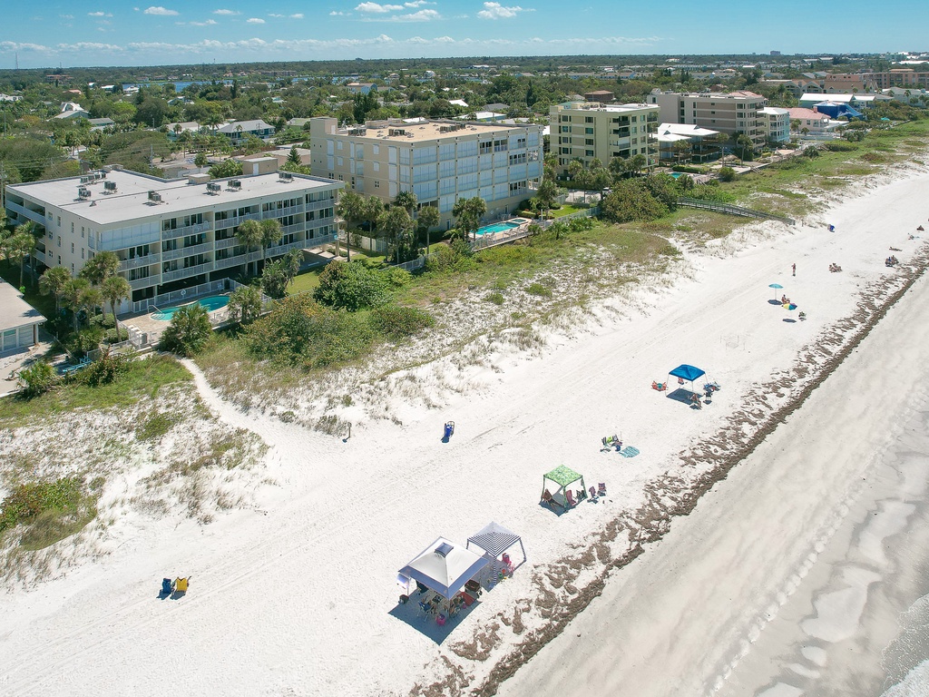 Beachfront properties stretch along pristine white sand, offering direct access to the Gulf Coast's sparkling waters and natural dunes.