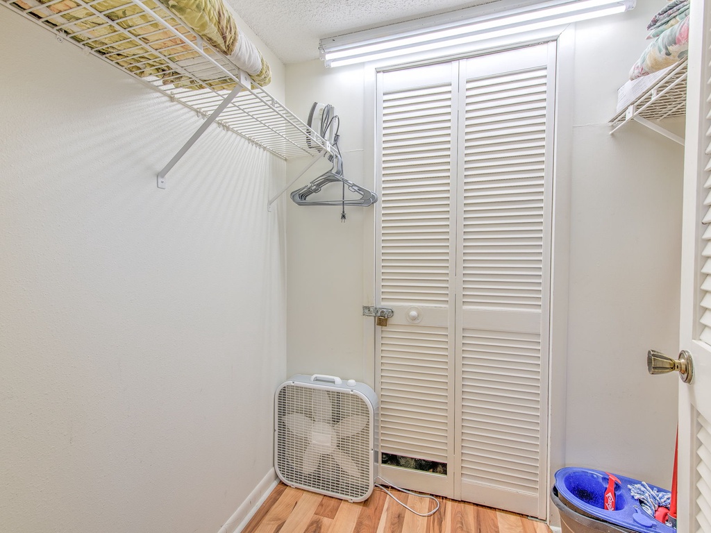 Your walk-in closet offers organized storage with wire shelving, hanging space, and a convenient fan for air circulation during your stay.