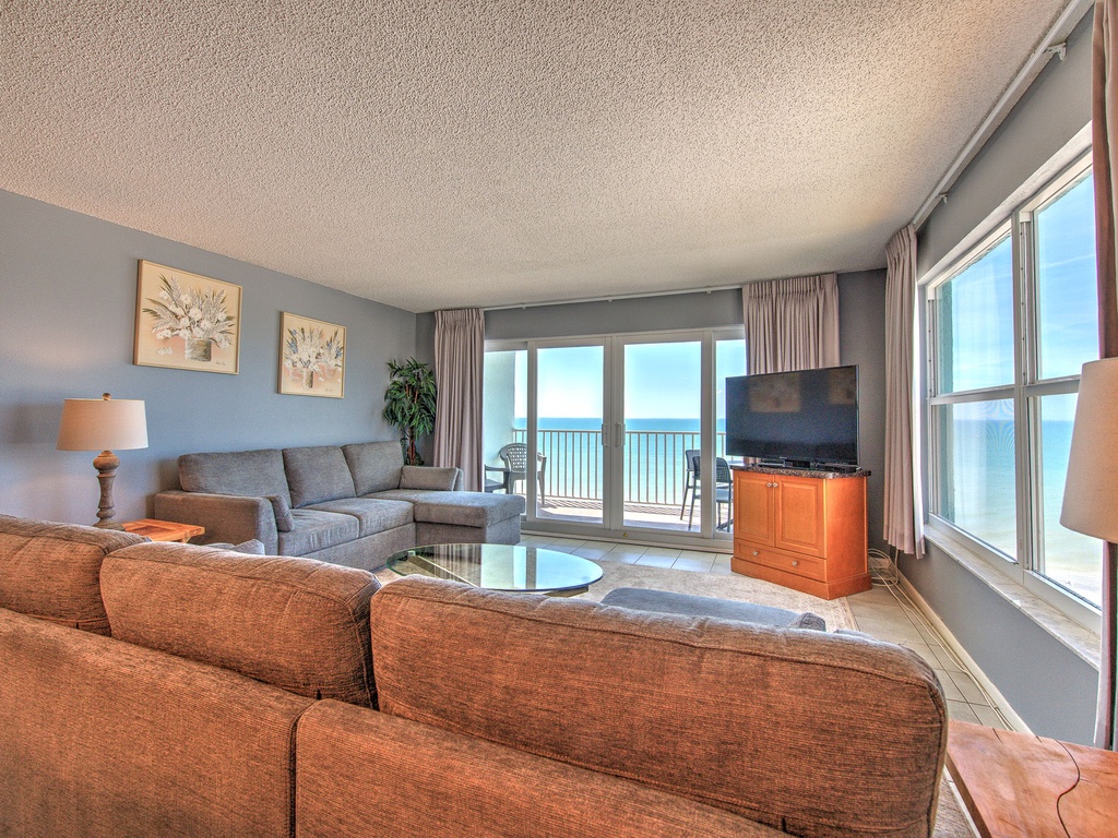 Relax in your oceanfront living room where breathtaking sea views greet you through floor-to-ceiling windows and sliding doors to your private balcony.