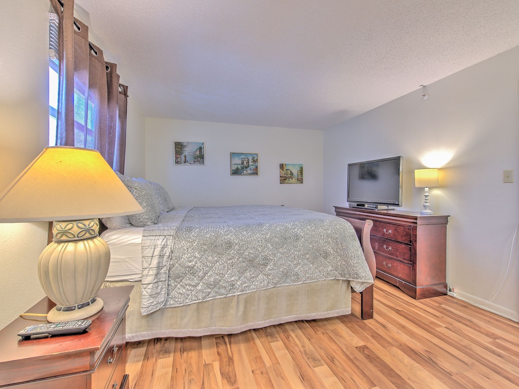 Sink into your cozy bedroom's plush bedding, with warm lamplight creating the perfect ambiance for relaxation after your adventures.