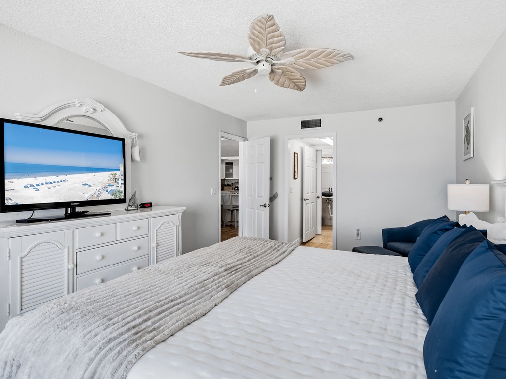 Wake up to beach scenes on your flat-screen TV in this serene bedroom, complete with coastal-inspired ceiling fan and crisp linens.