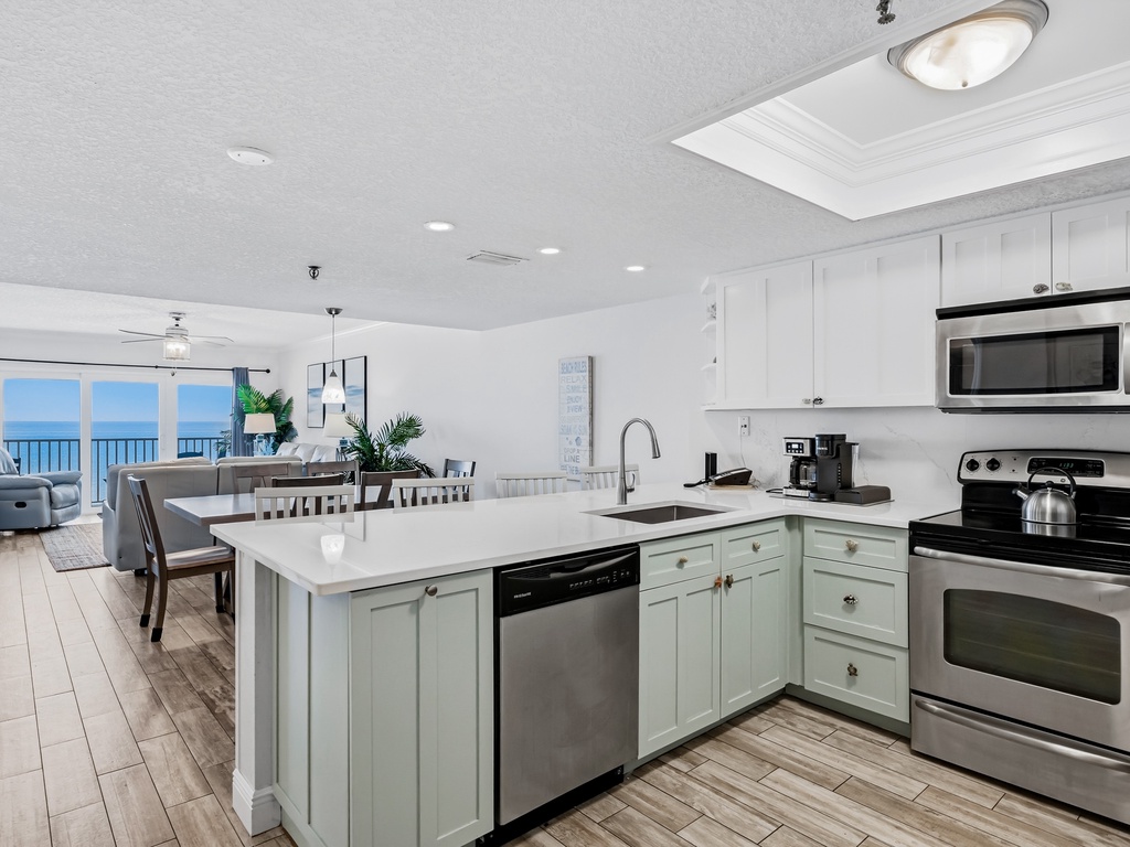 Cook your favorite meals in this bright, modern kitchen while soaking in stunning ocean views through the expansive windows.
