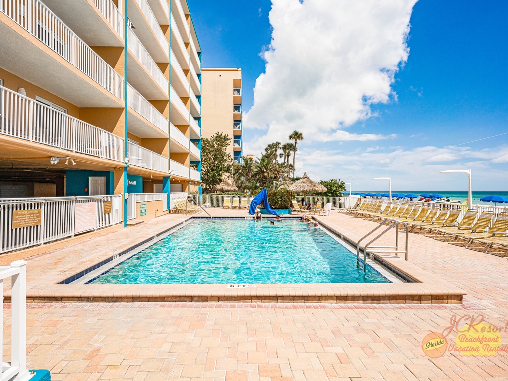 Dive into your own slice of paradise with this sparkling pool overlooking the beach, where sunny days and ocean breezes await.