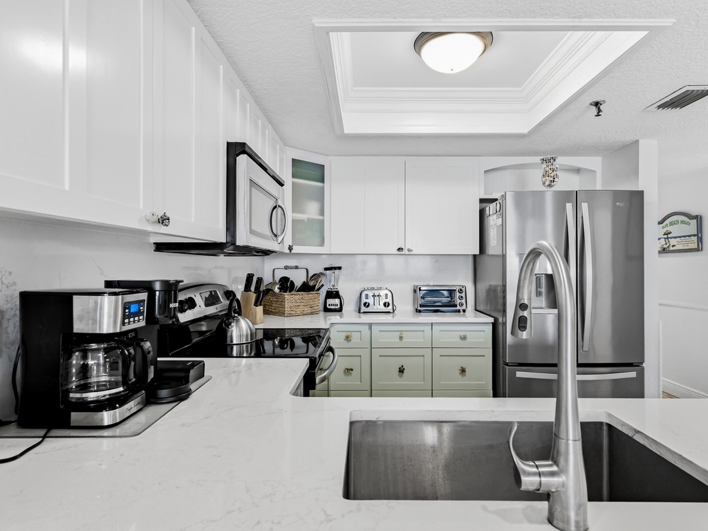 Your fully equipped kitchen awaits with stainless steel appliances, coffee maker, and everything needed to create memorable meals during your stay.