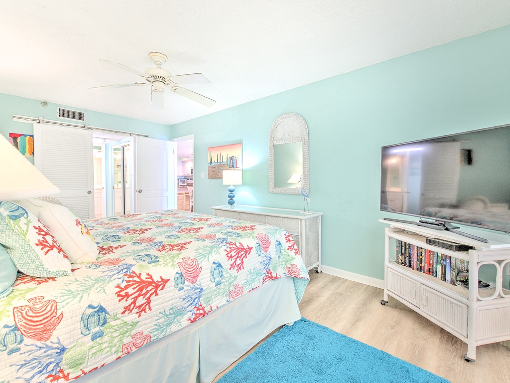 Your bright coastal bedroom features ocean-themed linens and soothing mint walls, creating the perfect seaside retreat for restful nights.
