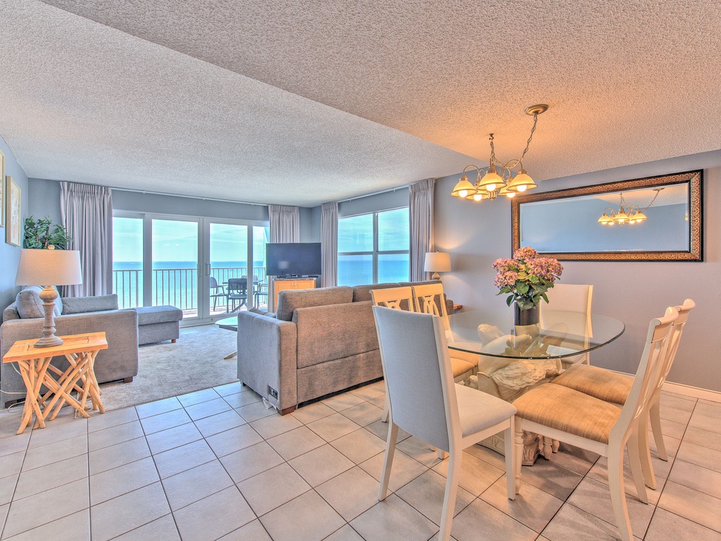Relax in your bright oceanfront living space where floor-to-ceiling windows frame stunning sea views, perfect for morning coffee or evening dinners.