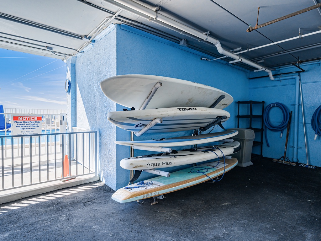 A convenient storage area with stacked surfboards and water sports equipment ready for your aquatic adventures.