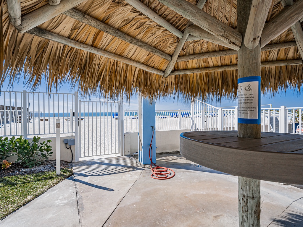 Rinse off salt and sand at your private outdoor shower station, complete with thatched roof shade and beach views.