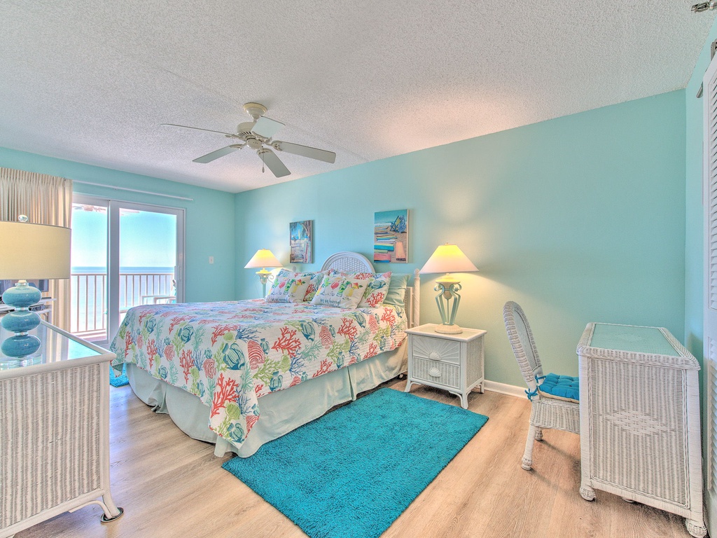 Wake to ocean breezes in your serene bedroom, where tropical décor and a private balcony create the perfect coastal retreat.