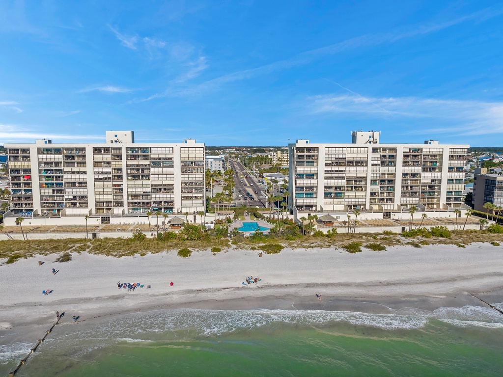 Beachfront complex offering direct access to pristine white sand and emerald waters, with pool facilities and coastal convenience.