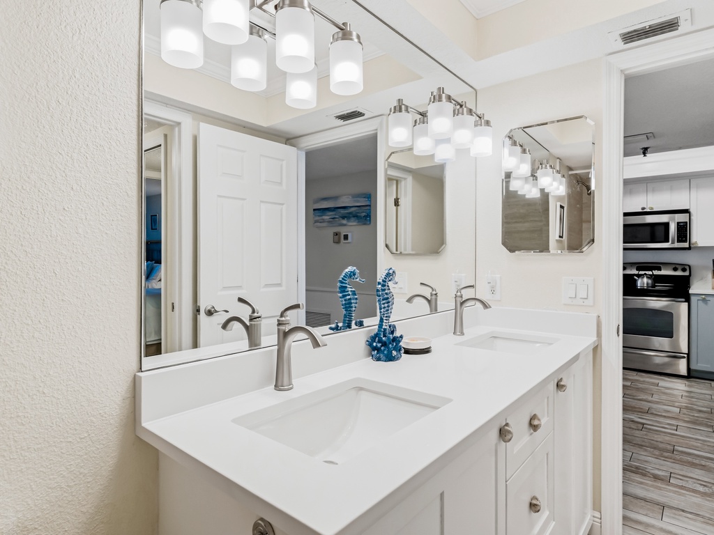 Beautiful dual-sink vanity with elegant lighting where you can start your mornings refreshed in this thoughtfully designed space.