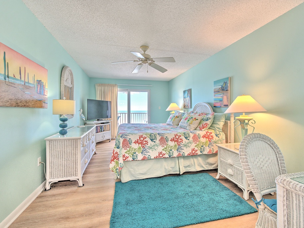 Drift off in your tranquil coastal bedroom, where soft sea-glass walls and tropical florals create the perfect beach retreat ambiance.