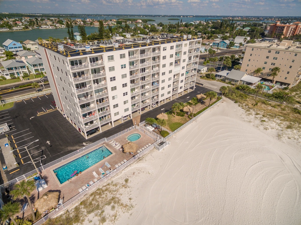 Beachfront property with swimming pool and direct beach access in a coastal community setting.