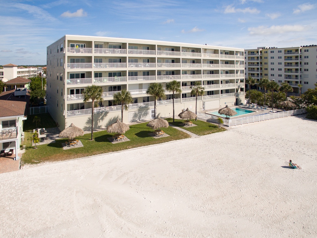 Beachfront property featuring white sand access, swimming pool, and multiple balconied accommodations in a prime coastal location.