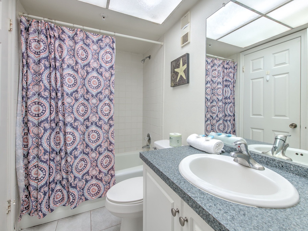 Your private bathroom features fresh towels, natural skylight, and all essentials for a refreshing start to each day.