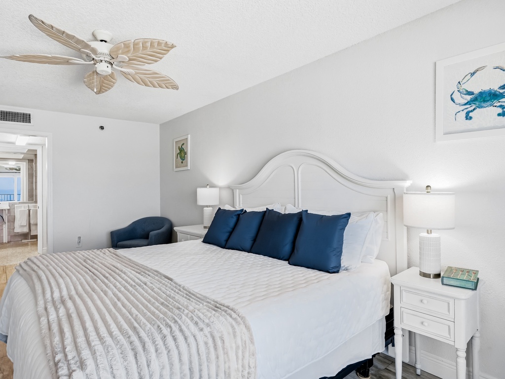 Drift off in this serene coastal bedroom where crisp white linens and navy accents create your perfect seaside retreat.